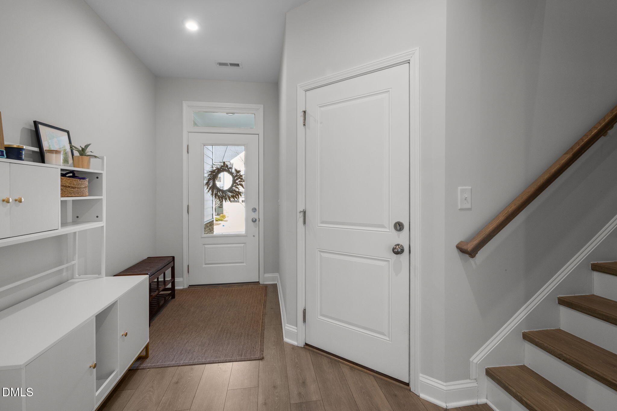 6523 Amber Springs Drive Durham, NC 27713 - Photo 6 of 32 a hallway with windows and stairs