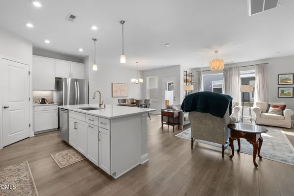 a large kitchen with stainless steel appliances kitchen island granite countertop a large island in the center