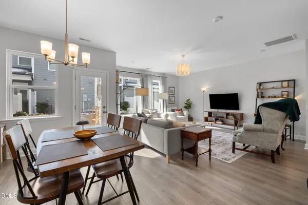 a living room with furniture a flat screen tv and a large window