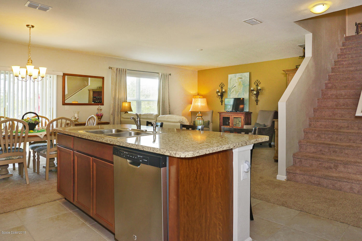 4637 Amaca Bay Lane Melbourne, FL 32935 - Photo 12 of 52 a kitchen with center island table and chairs