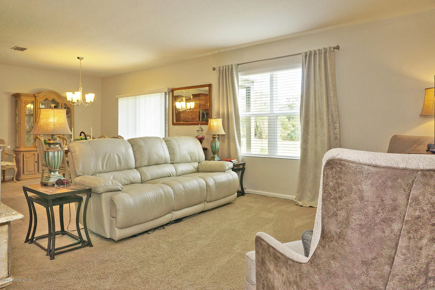 4637 Amaca Bay Lane Melbourne, FL 32935 - Photo 14 of 52 a living room with furniture and a large window