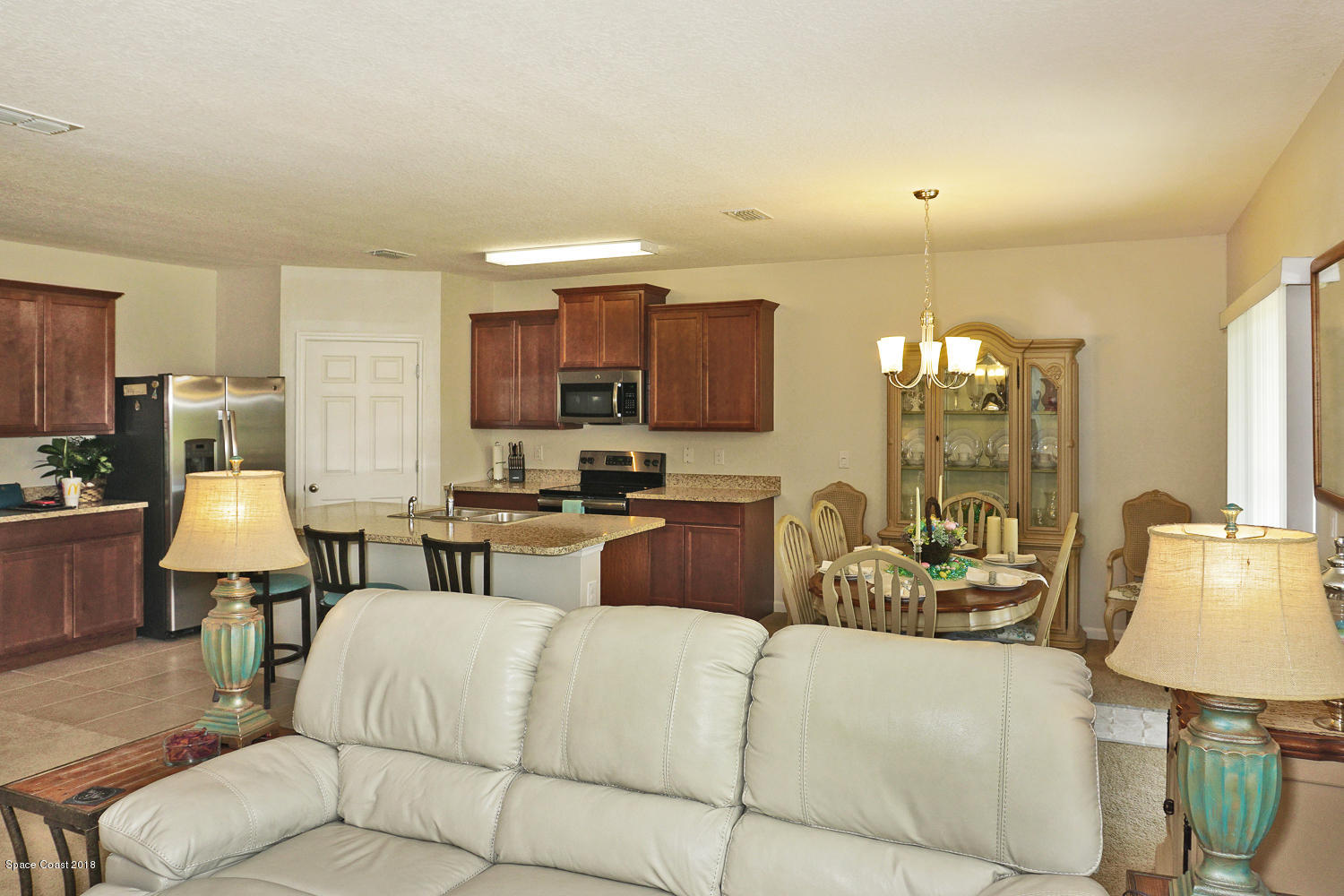 4637 Amaca Bay Lane Melbourne, FL 32935 - Photo 15 of 52 a living room with furniture and a lamp