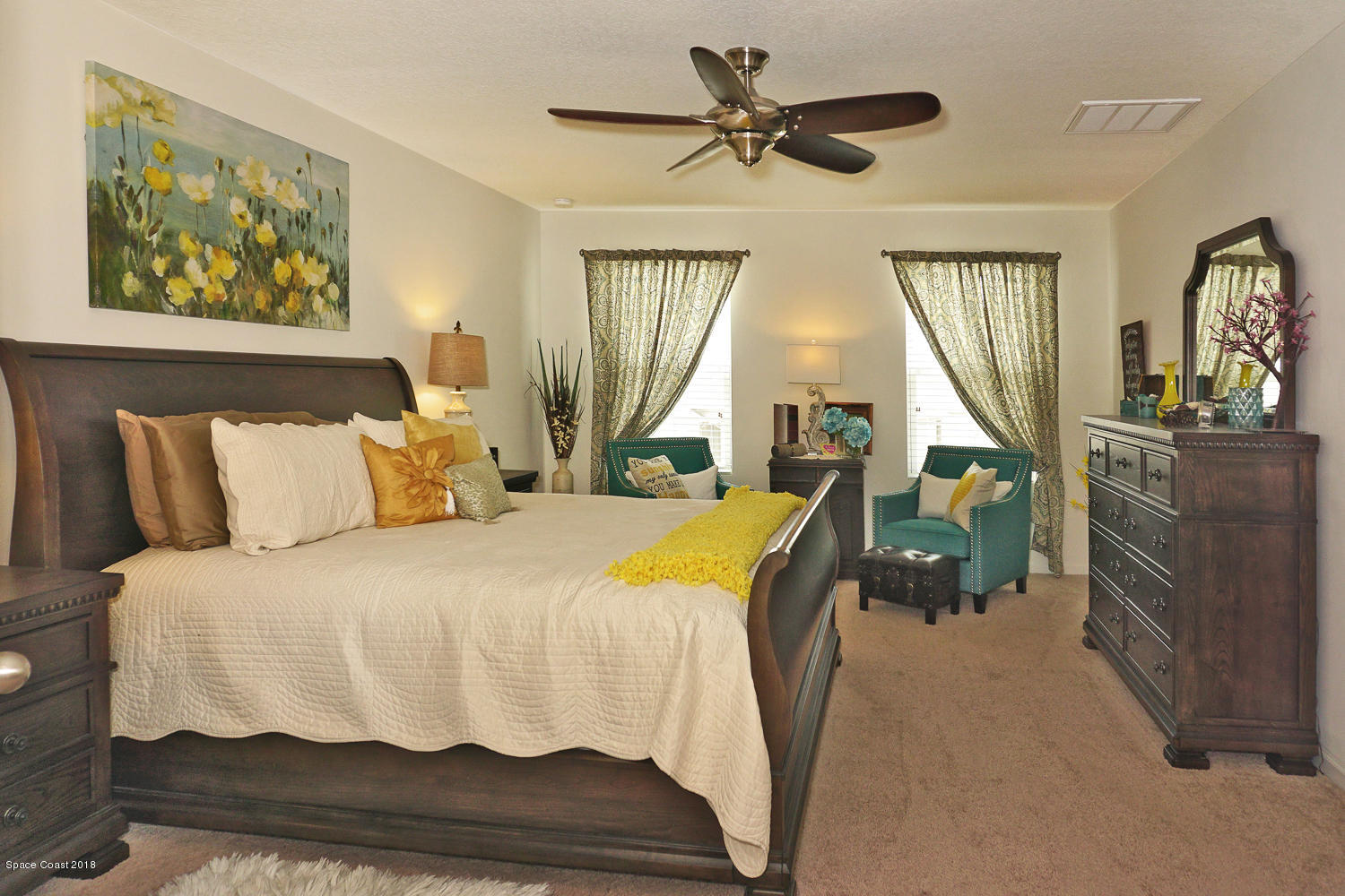 4637 Amaca Bay Lane Melbourne, FL 32935 - Photo 18 of 52 a bedroom with a bed a dresser and potted plants on the table