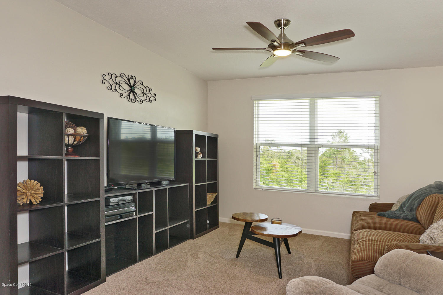 4637 Amaca Bay Lane Melbourne, FL 32935 - Photo 21 of 52 a living room with furniture a window and a ceiling fan