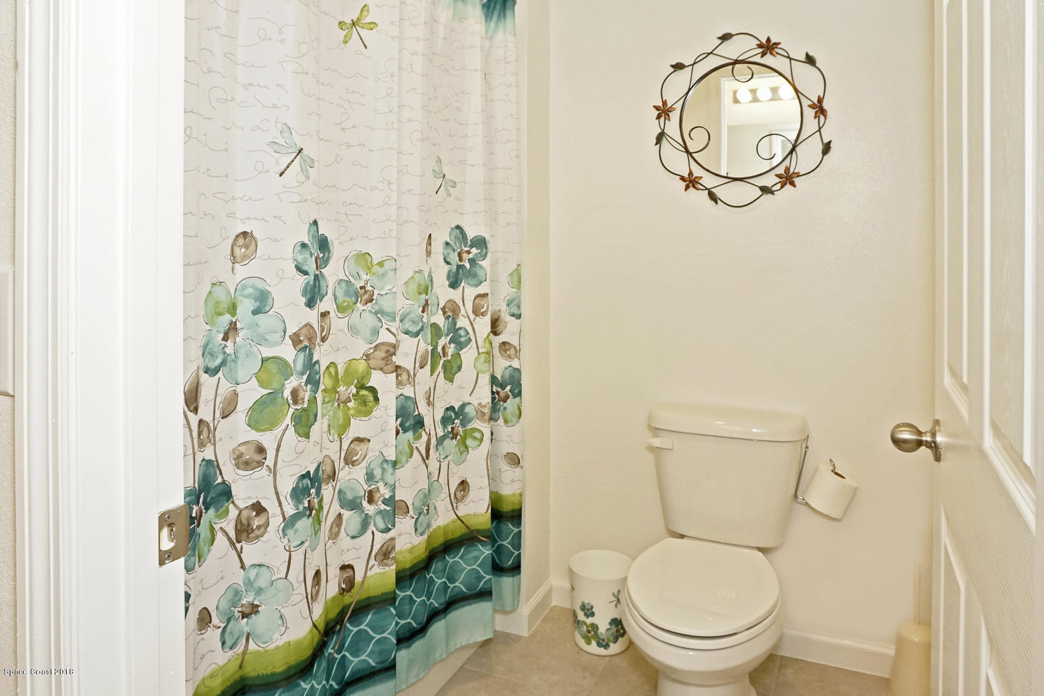 4637 Amaca Bay Lane Melbourne, FL 32935 - Photo 24 of 52 a white toilet sitting next to a shower curtain