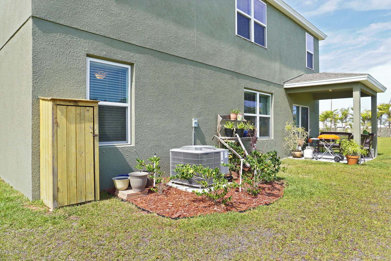 4637 Amaca Bay Lane Melbourne, FL 32935 - Photo 42 of 52 a view of a backyard with table and chairs