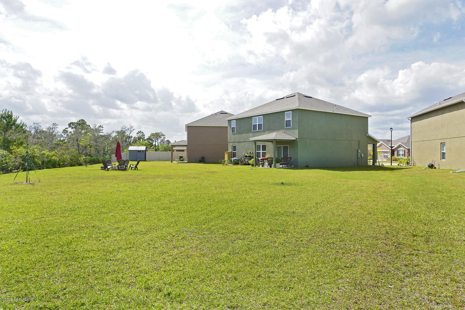 4637 Amaca Bay Lane Melbourne, FL 32935 - Photo 46 of 52 a yellow house with garden in front of it