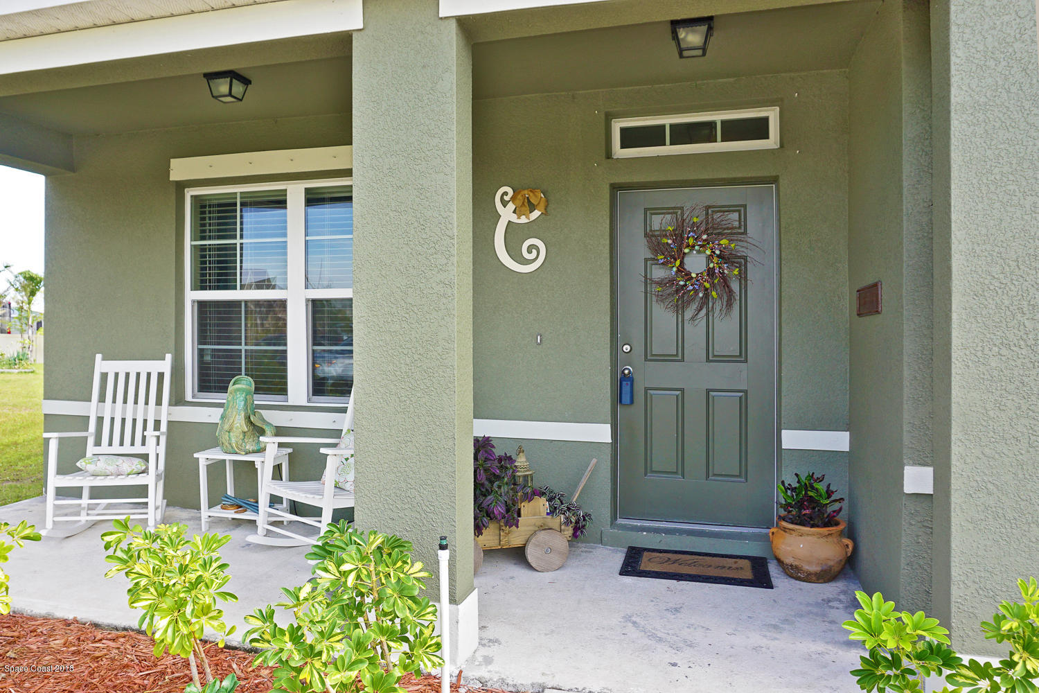 4637 Amaca Bay Lane Melbourne, FL 32935 - Photo 48 of 52 a front view of a house with outdoor seating and plants