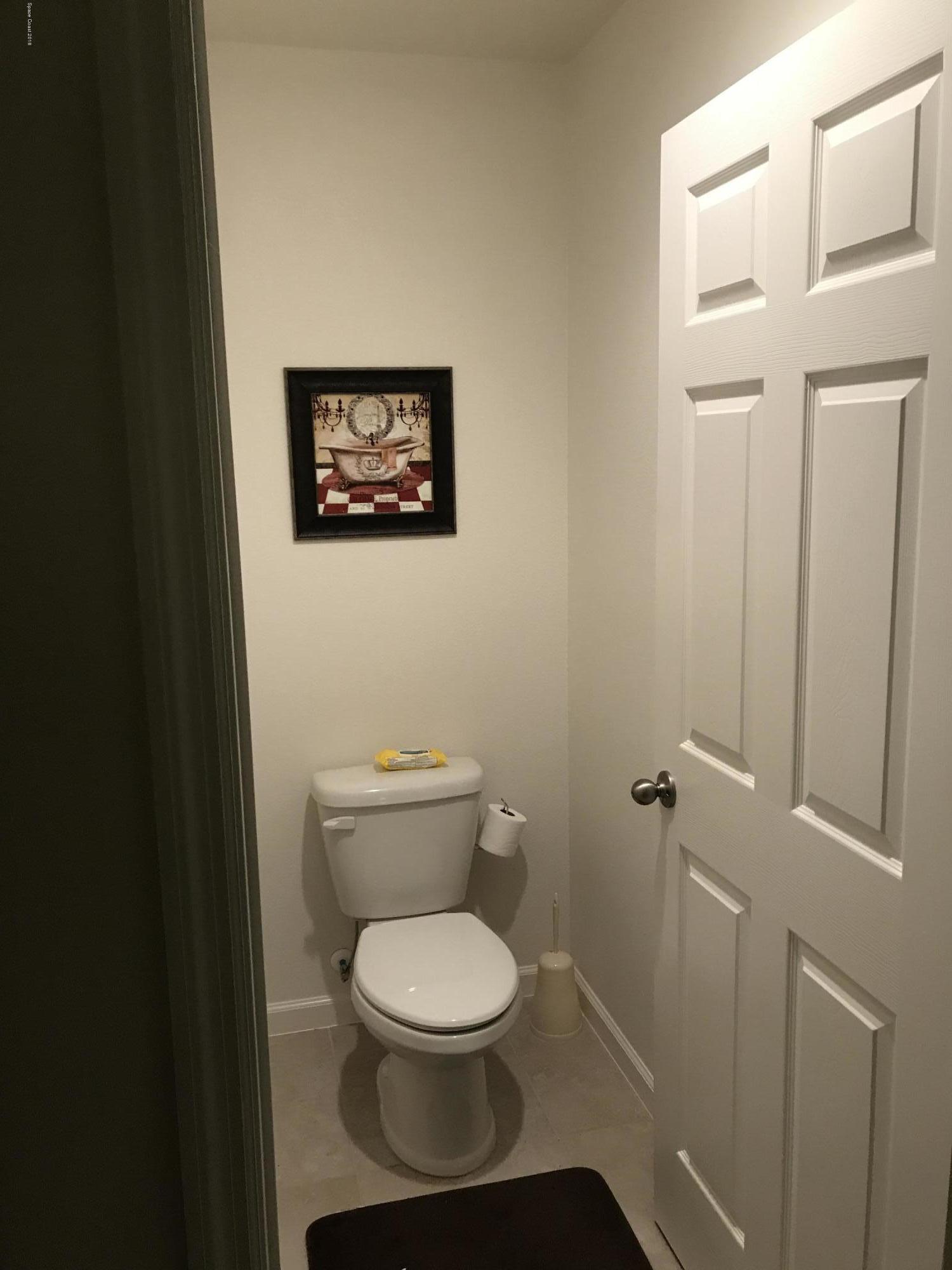 4637 Amaca Bay Lane Melbourne, FL 32935 - Photo 49 of 52 a white toilet sitting next to a white sink