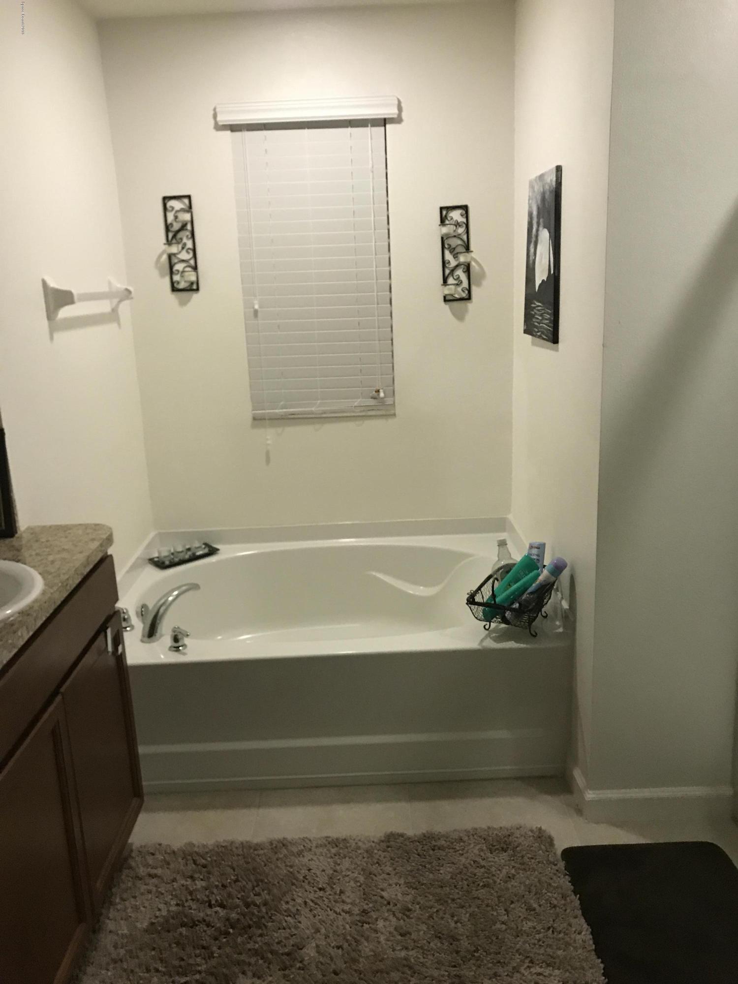 4637 Amaca Bay Lane Melbourne, FL 32935 - Photo 51 of 52 a bathroom with a bathtub and shower