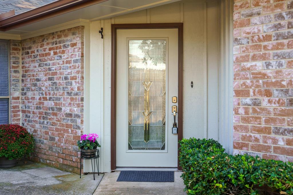 6512 Mc Cormick Ranch Court Plano, TX 75023 - Photo 11 of 40 a front view of a house with a garden
