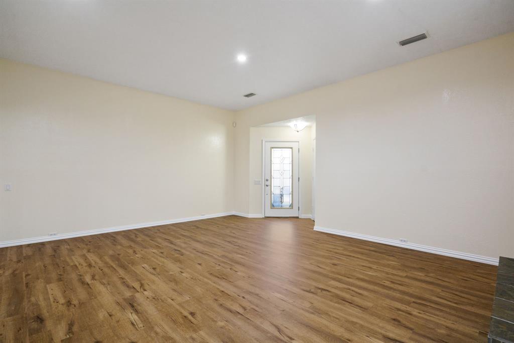 6512 Mc Cormick Ranch Court Plano, TX 75023 - Photo 13 of 40 a view of an empty room with wooden floor