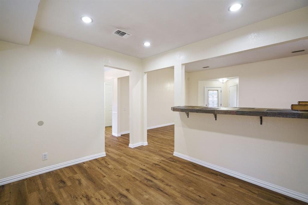 6512 Mc Cormick Ranch Court Plano, TX 75023 - Photo 15 of 40 a view of a big room with wooden floor and windows