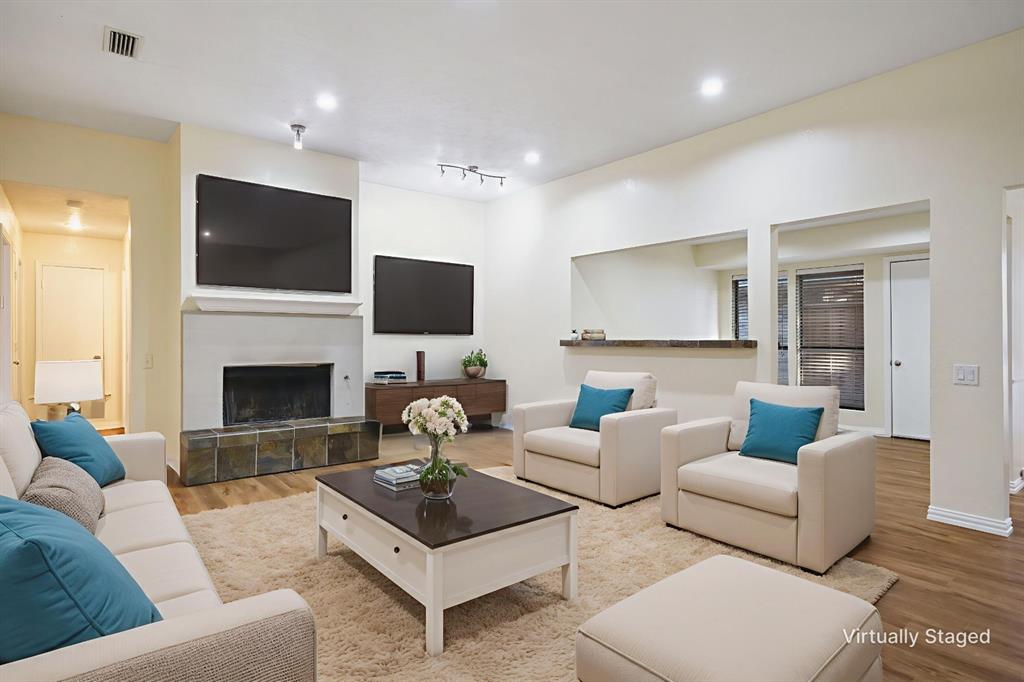 6512 Mc Cormick Ranch Court Plano, TX 75023 - Photo 4 of 40 a living room with furniture a flat screen tv and a fireplace