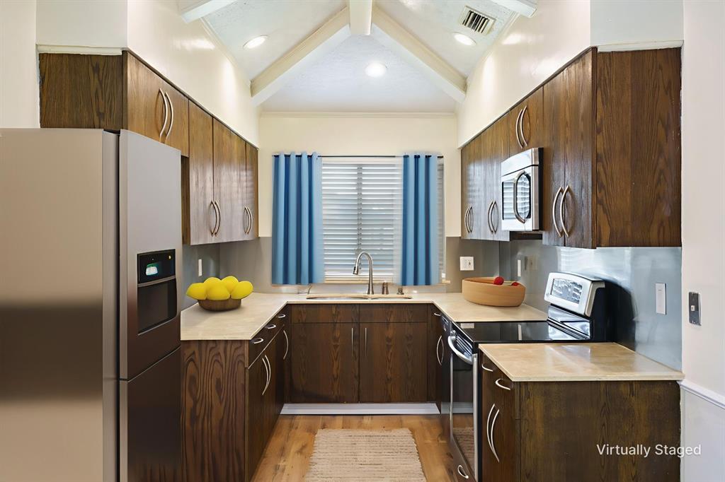 6512 Mc Cormick Ranch Court Plano, TX 75023 - Photo 5 of 40 a kitchen that has a sink and a refrigerator in it
