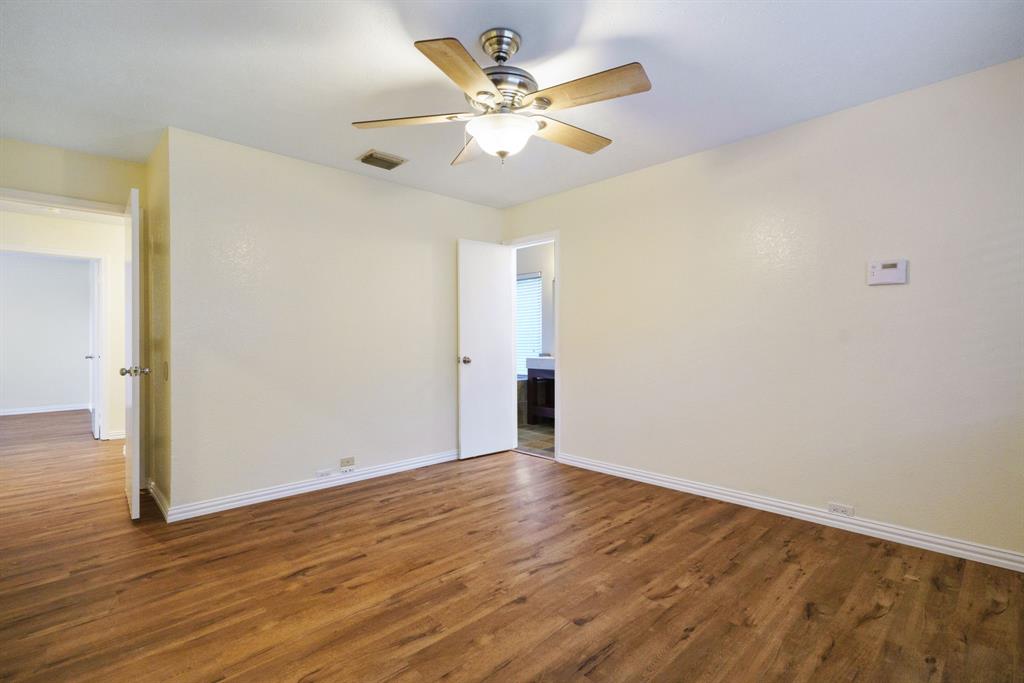 6512 Mc Cormick Ranch Court Plano, TX 75023 - Photo 8 of 40 an empty room with wooden floor and a ceiling fan