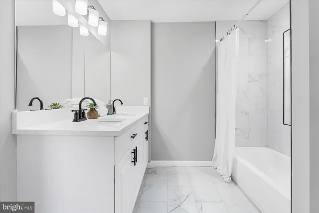 a bathroom with a sink a mirror and a bathtub