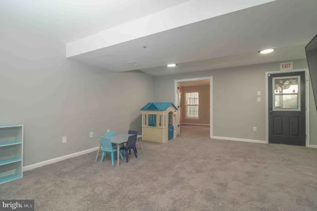 an empty room with furniture and a window