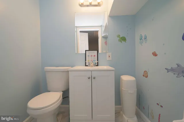 a bathroom with a toilet sink and mirror
