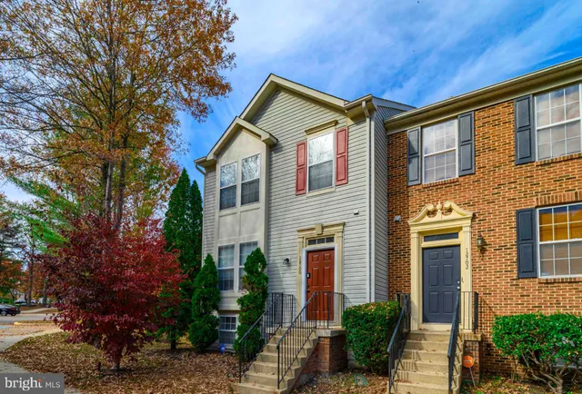 a view of a house with a yard and potted plants