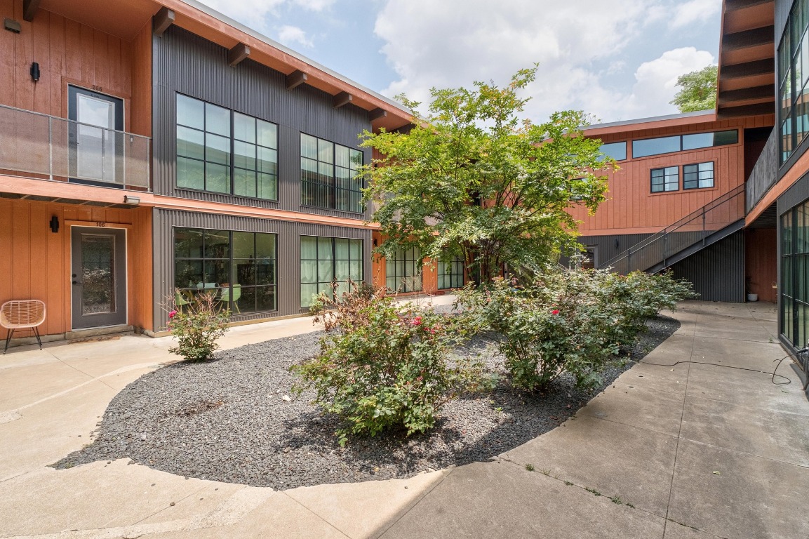 front view of a brick house with a yard