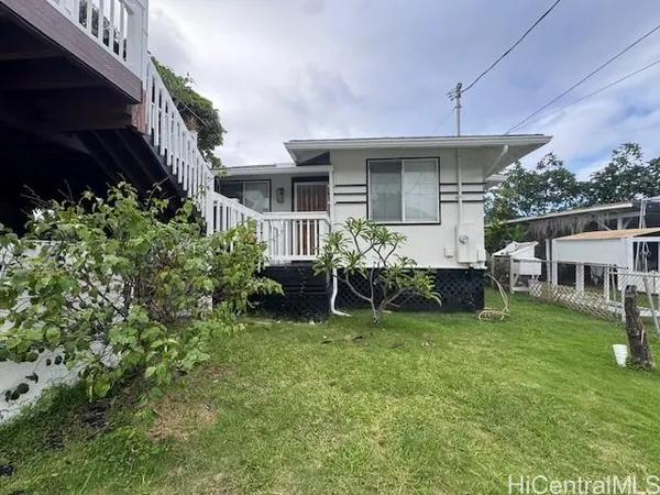 a view of a house with backyard sitting area and garden