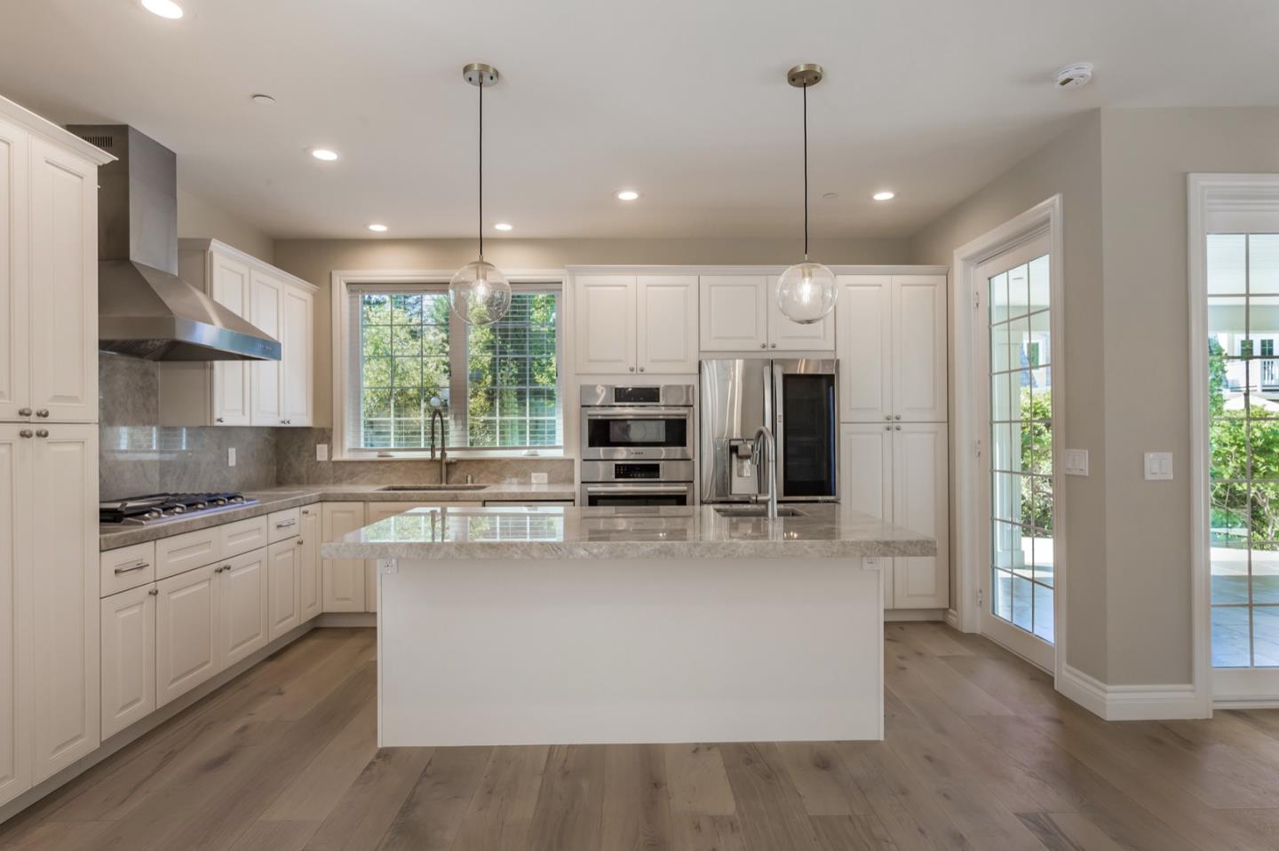 11 A Cowell Lane Atherton, CA 94027 - Photo 12 of 35 a large kitchen with kitchen island a large island in the center