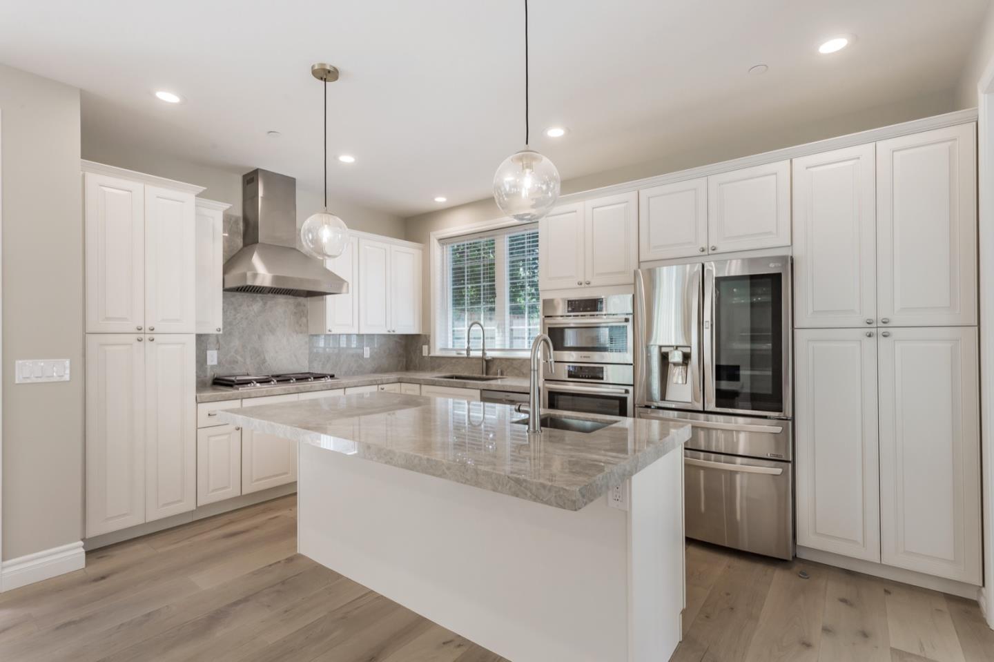 11 A Cowell Lane Atherton, CA 94027 - Photo 13 of 35 a kitchen with stainless steel appliances granite countertop a stove a refrigerator a oven and white cabinets with wooden floor