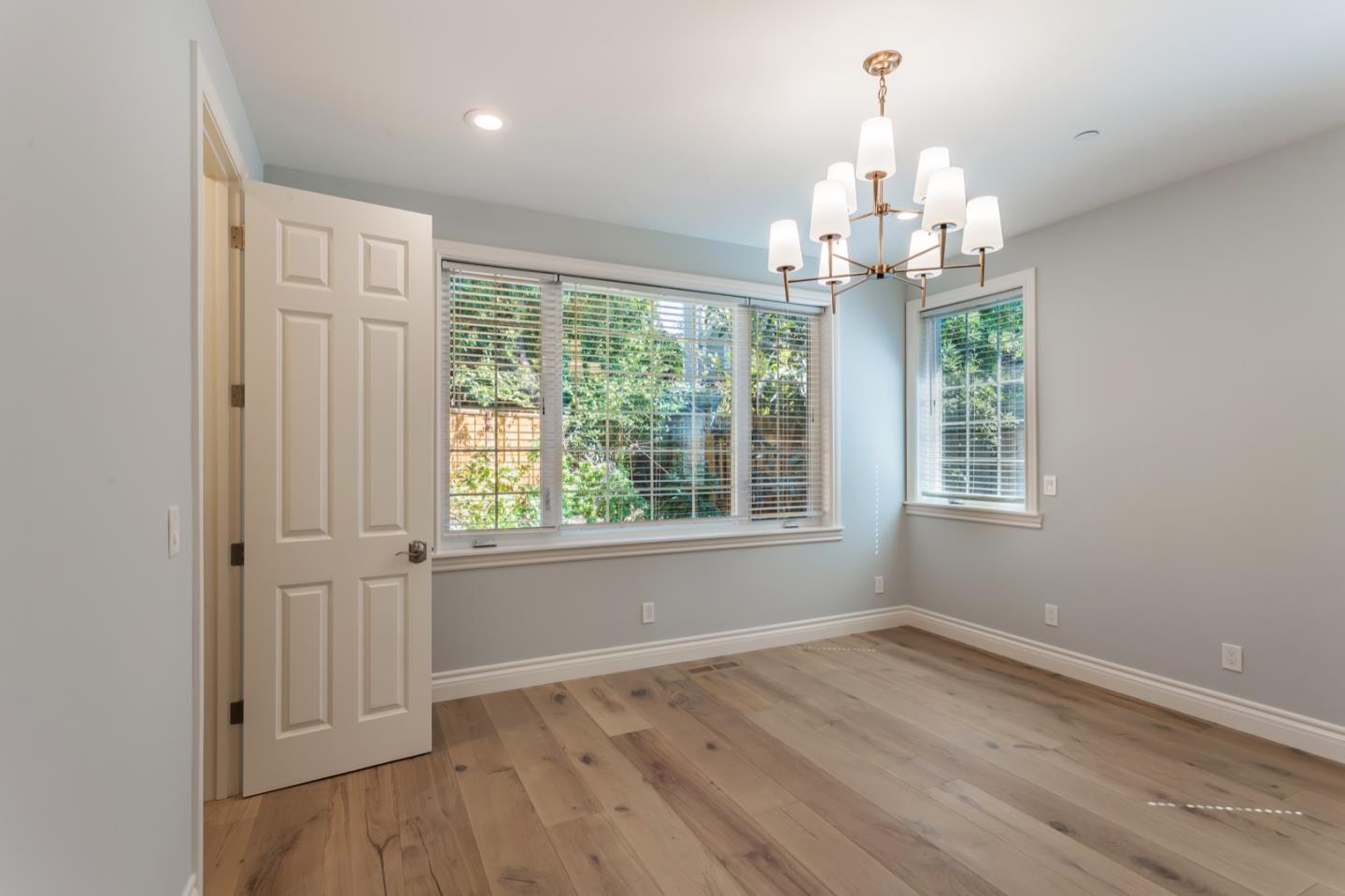 11 A Cowell Lane Atherton, CA 94027 - Photo 23 of 35 an empty room with wooden floor exposed radiator and windows