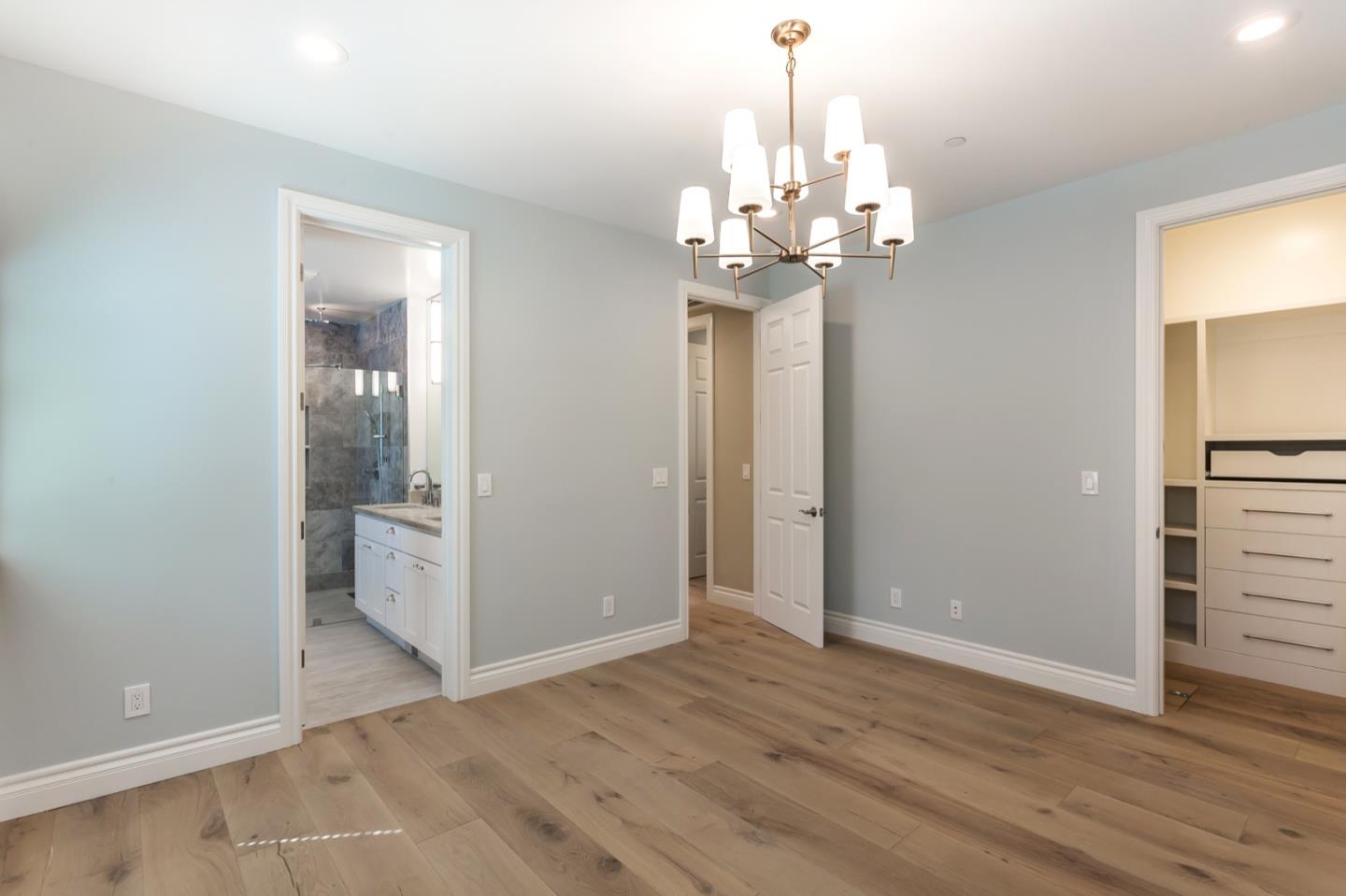 11 A Cowell Lane Atherton, CA 94027 - Photo 26 of 35 an empty room with wooden floor chandelier and windows