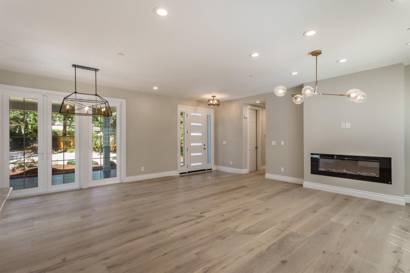 11 A Cowell Lane Atherton, CA 94027 - Photo 8 of 35 an empty room with wooden floor and kitchen view
