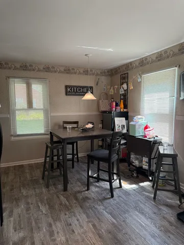 a view of a dining room with furniture and wooden floor