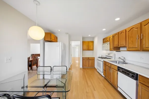 a kitchen with stainless steel appliances granite countertop a sink counter space and a stove top oven