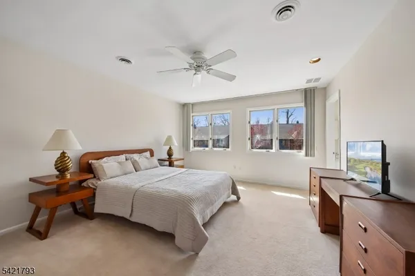 a bedroom with a bed dresser and a window