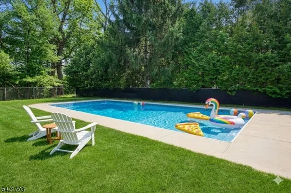a swimming pool with some trees in the background