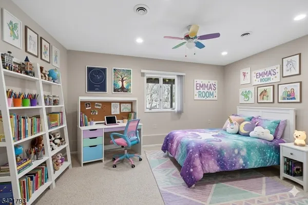 a bedroom with a bed a book shelf and a book shelf