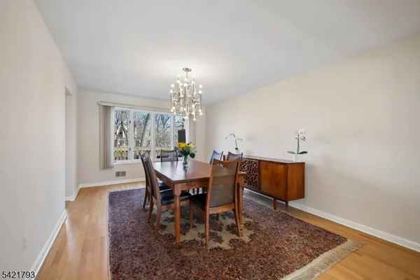 a view of a dining room with furniture and chandelier