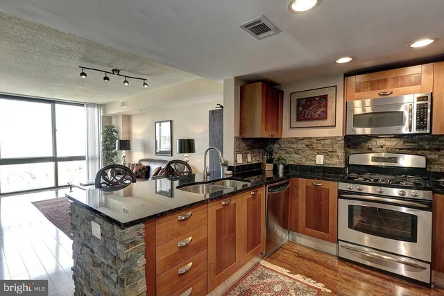a bathroom with a sink mirror vanity and toilet
