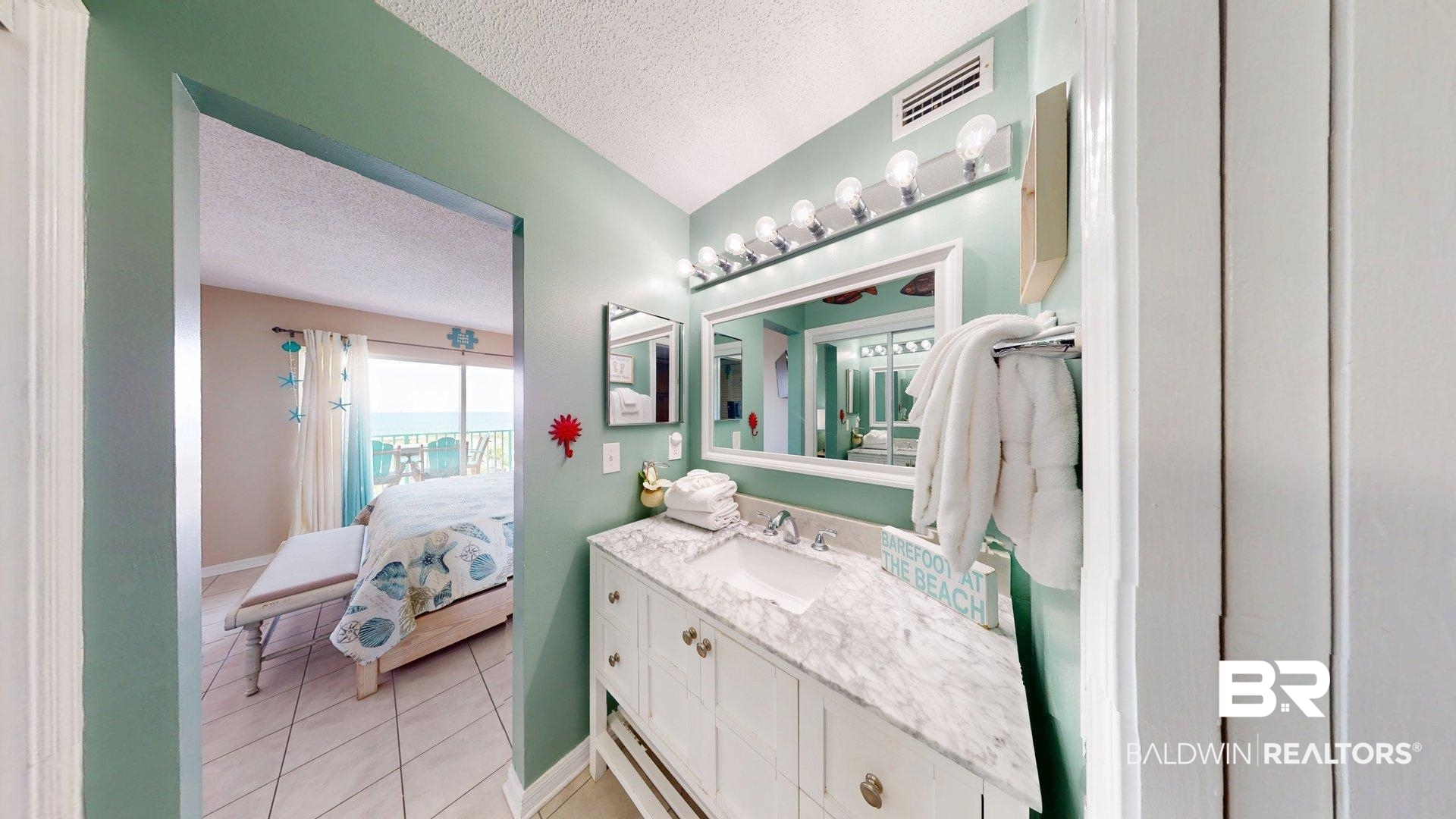 645 Plantation Road, Unit 6503 Gulf Shores, AL 36542 - Photo 41 of 53 Ensuite bathroom with a textured ceiling, vanity, and light tile patterned flooring