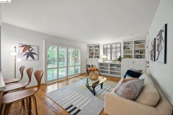 a living room with furniture and a floor to ceiling window