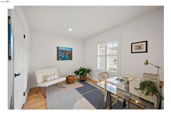 a living room with a couch and a potted plant