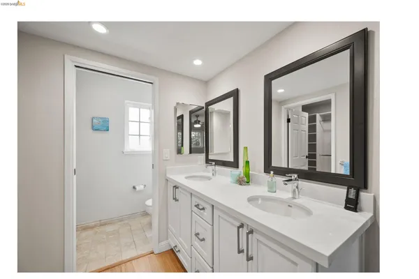 a bathroom with 2 sink and a mirror