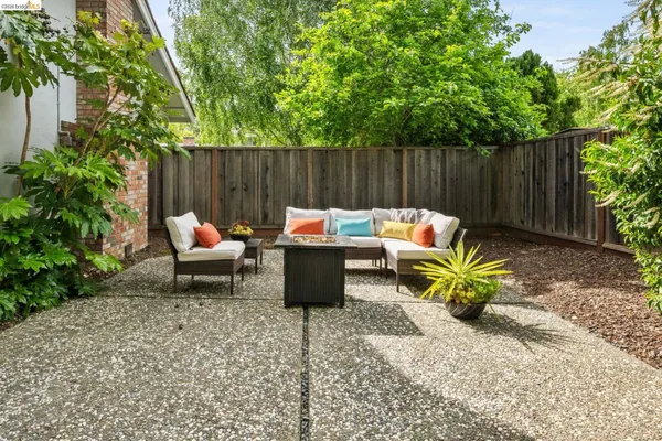 a backyard of a house with outdoor seating