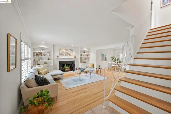 a view of a livingroom with furniture staircase and a fireplace