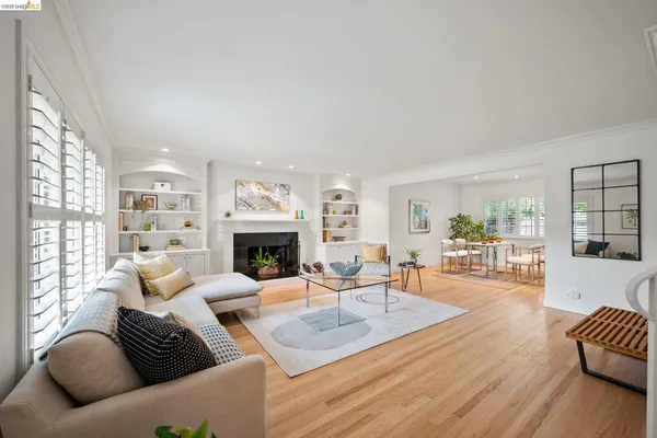 a living room with furniture a fireplace and a large window