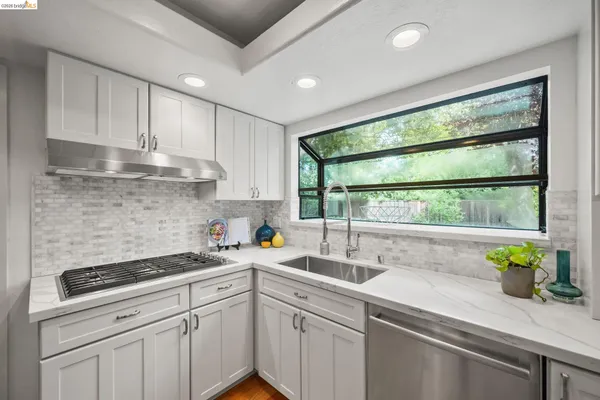 a kitchen with stainless steel appliances white cabinets and a granite counter tops