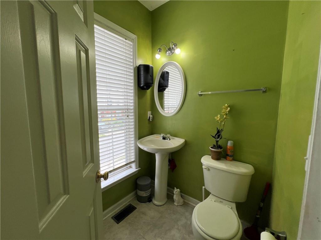 3914 Howell Park Road Duluth, GA 30096 - Photo 10 of 33 a bathroom with a toilet and a sink