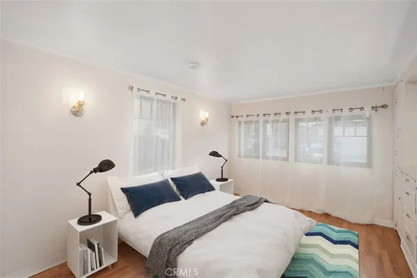 a bedroom with a bed and a dresser in it