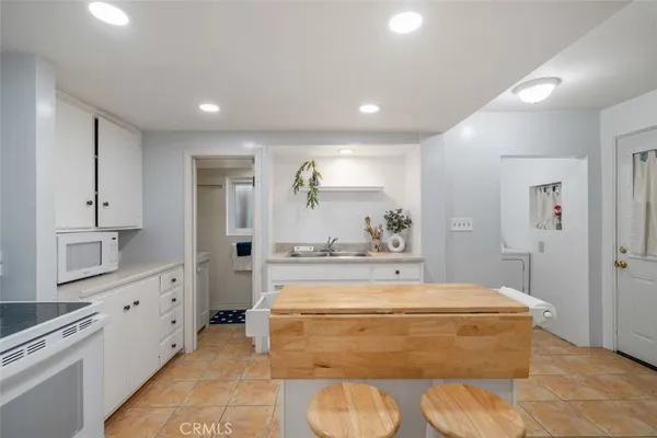 a kitchen with a stove refrigerator and sink