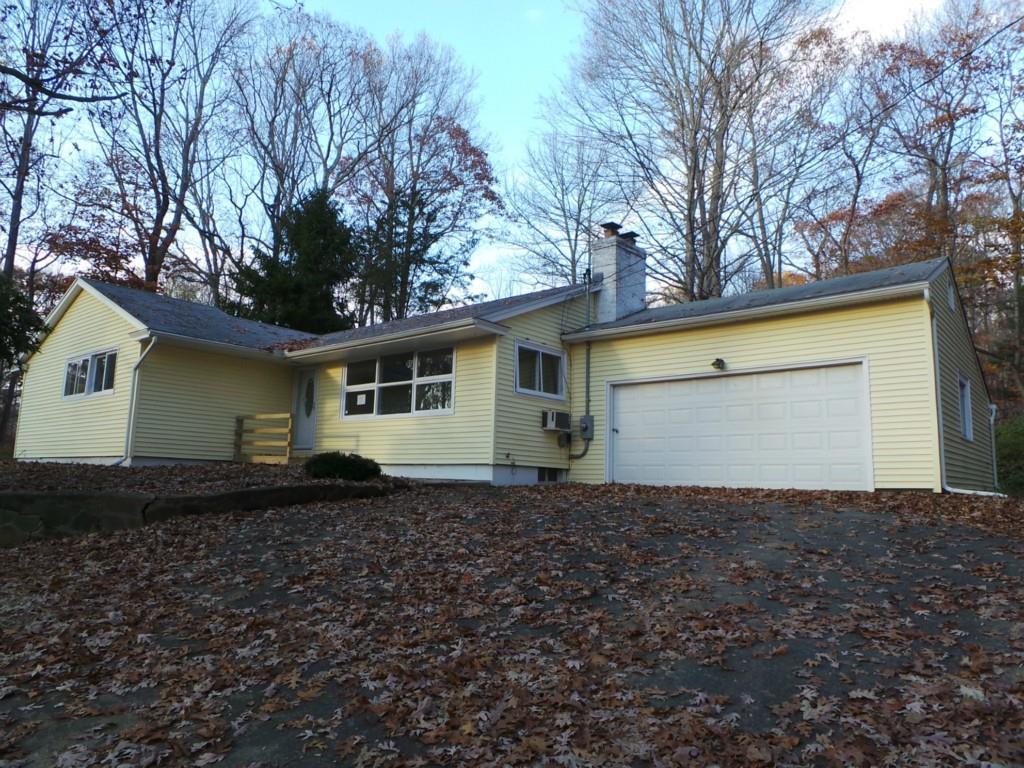 a front view of a house with trees